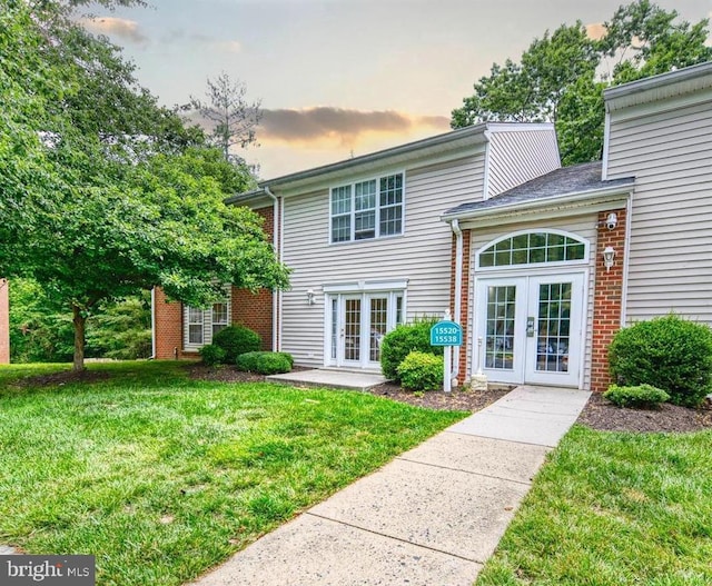 15524 Horseshoe Ln, Woodbridge, VA 22191 - view of front facade with french doors, a yard, and brick siding