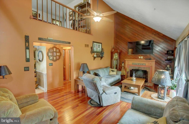 50 Valleyview Dr, Littlestown, PA 17340 - living area featuring ceiling fan, high vaulted ceiling, wood finished floors, wooden walls, and a fireplace