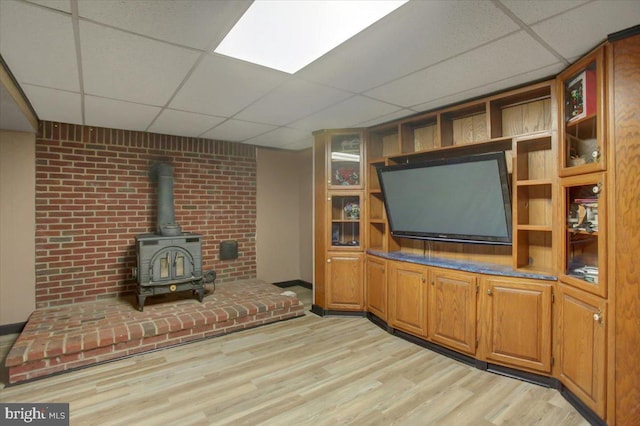 50 Valleyview Dr, Littlestown, PA 17340 - living room with a drop ceiling, a wood stove, and light wood-type flooring