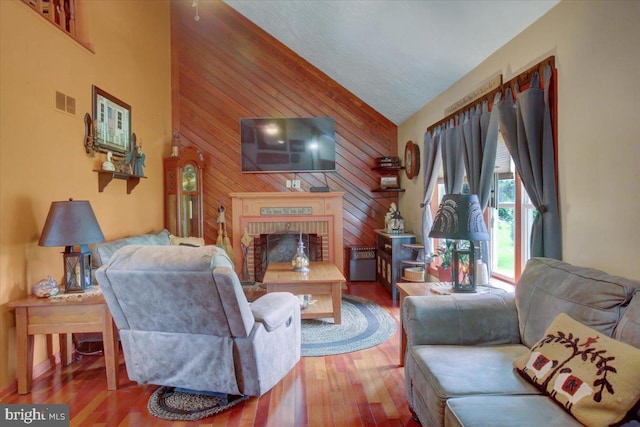 50 Valleyview Dr, Littlestown, PA 17340 - living room with wooden walls, a brick fireplace, wood finished floors, and high vaulted ceiling