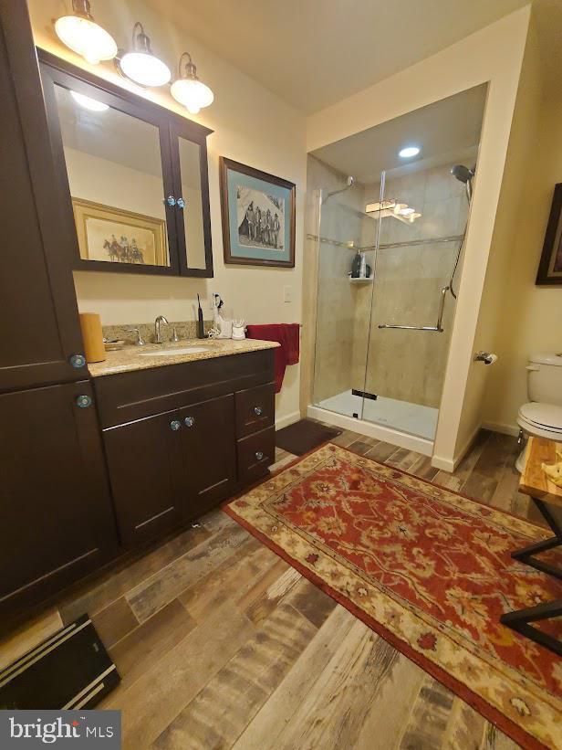 10 Stevens Ln, Tabernacle, NJ 08088 - bathroom with wood finished floors, a stall shower, vanity, toilet, and baseboards