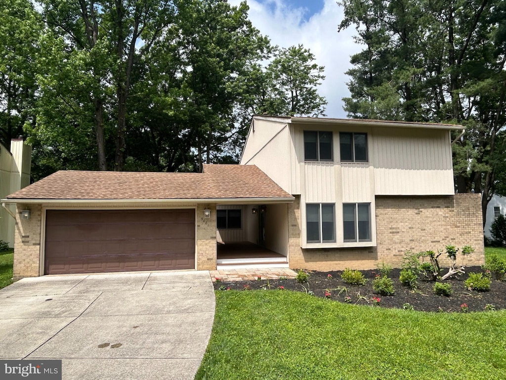 9001 Wetbanks Ct, Columbia, MD 21045 - view of front facade with brick siding, a garage, concrete driveway, and a front lawn