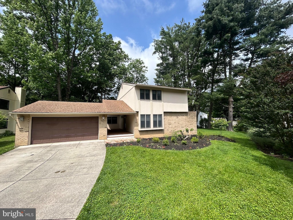 9001 Wetbanks Ct, Columbia, MD 21045 - view of front facade with brick siding, a garage, concrete driveway, and a front lawn