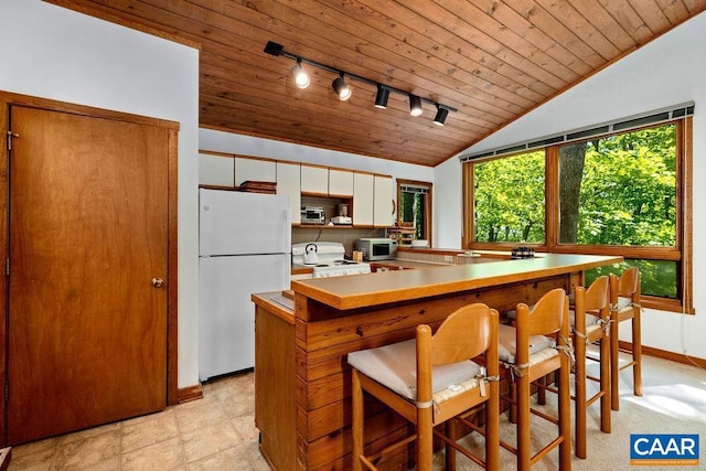 98 Pedlars Pt, Roseland, VA 22967 - kitchen featuring freestanding refrigerator, track lighting, wood ceiling, vaulted ceiling, and stainless steel microwave