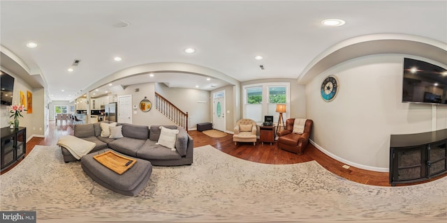 422 Hamilton St NW, Washington, DC 20011 - living area with wood finished floors, baseboards, arched walkways, stairs, and healthy amount of natural light