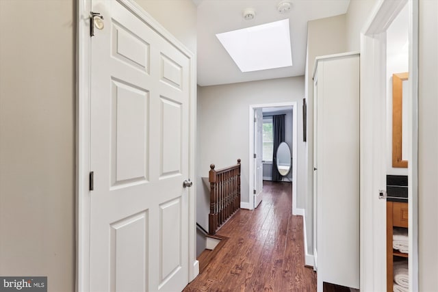 422 Hamilton St NW, Washington, DC 20011 - hall with a skylight, dark wood finished floors, baseboards, and an upstairs landing
