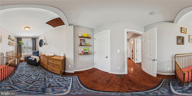 422 Hamilton St NW, Washington, DC 20011 - bedroom featuring arched walkways, baseboards, and wood finished floors