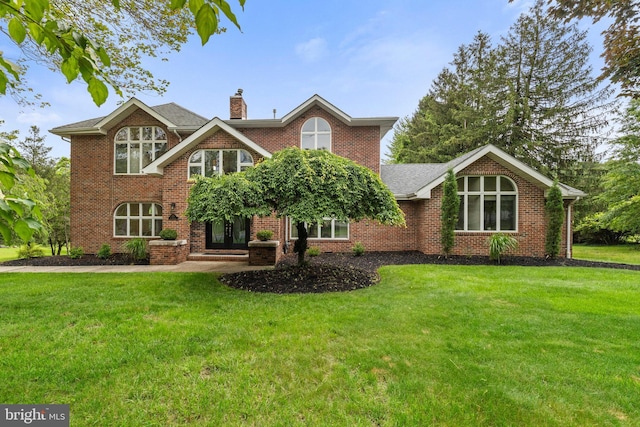 173 Old Beekman Rd, Monmouth Junction, NJ 08852 - view of front of property featuring a chimney, a front yard, brick siding, and roof with shingles