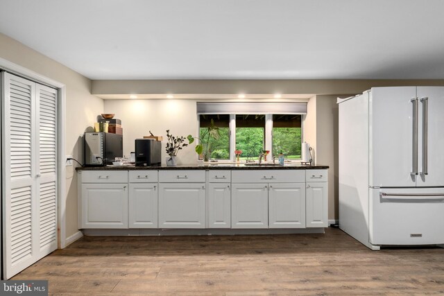 173 Old Beekman Rd, Monmouth Junction, NJ 08852 - kitchen with freestanding refrigerator, a sink, wood finished floors, and white cabinetry