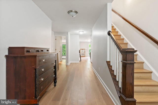 128 N Jay St, Middleburg, VA 20117 - corridor with light wood finished floors, stairway, and baseboards