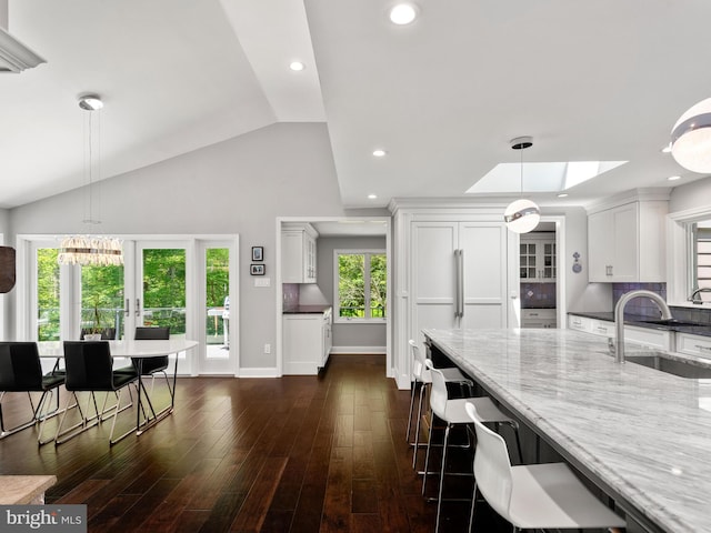 2762 Horseshoe Trl, Chester Springs, PA 19425 - kitchen with light stone countertops, decorative light fixtures, white cabinetry, a chandelier, and dark wood-type flooring