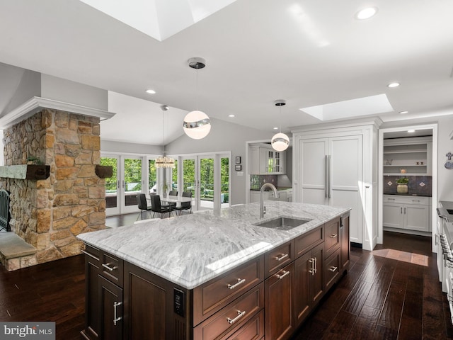 2762 Horseshoe Trl, Chester Springs, PA 19425 - kitchen with a skylight, dark wood finished floors, light stone counters, vaulted ceiling, and hanging light fixtures