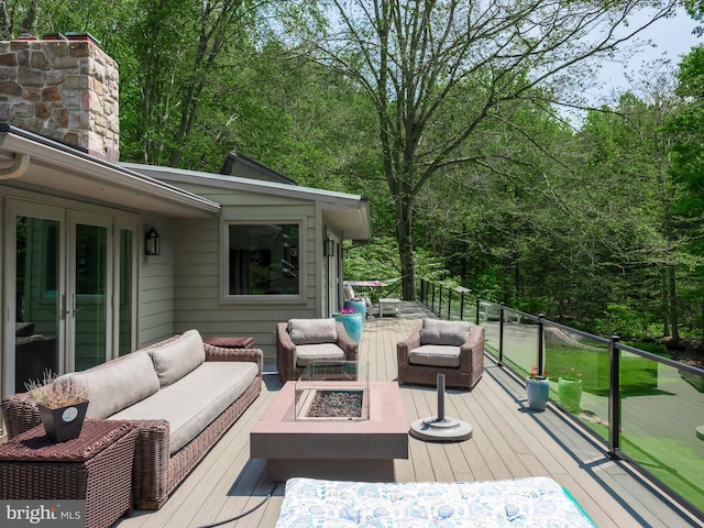 2762 Horseshoe Trl, Chester Springs, PA 19425 - wooden deck with an outdoor living space with a fire pit, french doors, and a wooded view