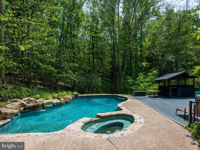 2762 Horseshoe Trl, Chester Springs, PA 19425 - view of swimming pool featuring a gazebo, a deck, a pool with connected hot tub, and a view of trees