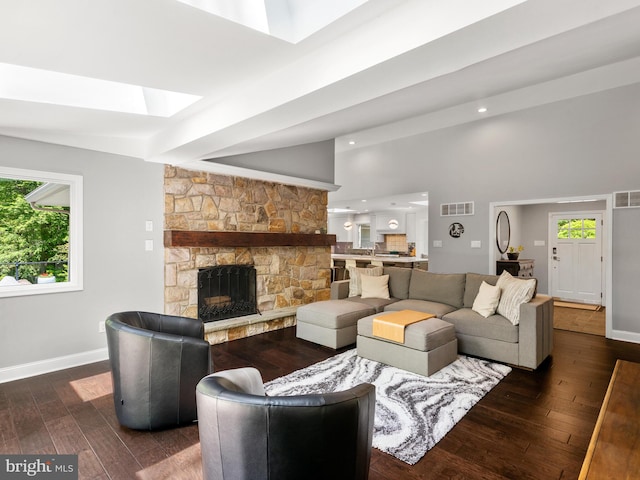 2762 Horseshoe Trl, Chester Springs, PA 19425 - living room with a skylight, dark wood-style flooring, a stone fireplace, recessed lighting, and a high ceiling
