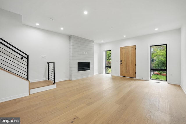 3802 T St NW, Washington, DC 20007 - unfurnished living room featuring stairway, recessed lighting, light wood finished floors, baseboards, and a fireplace