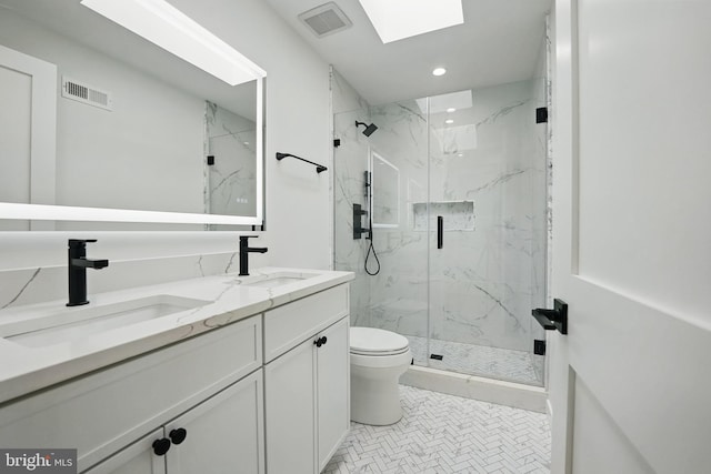 3802 T St NW, Washington, DC 20007 - full bathroom featuring toilet, a skylight, a marble finish shower, double vanity, and recessed lighting
