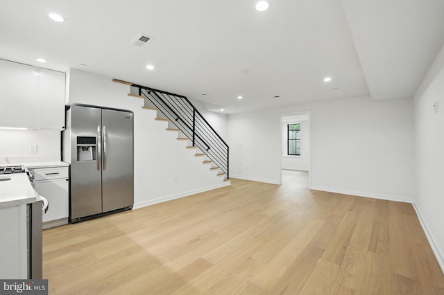 3802 T St NW, Washington, DC 20007 - kitchen with stainless steel appliances, white cabinets, light countertops, light wood-style floors, and recessed lighting