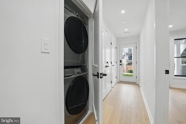 3802 T St NW, Washington, DC 20007 - laundry area with stacked washer / drying machine, light wood-type flooring, recessed lighting, and baseboards