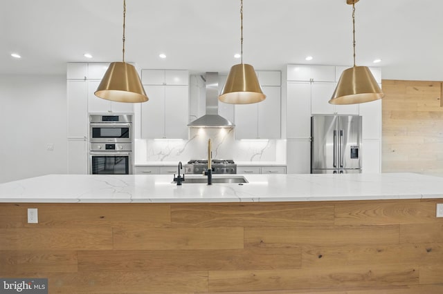 3802 T St NW, Washington, DC 20007 - kitchen featuring stainless steel appliances, wall chimney range hood, white cabinets, a spacious island, and pendant lighting