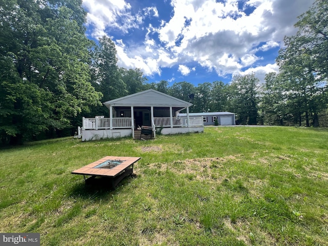 1037 Raven Rocks Rd, Springfield, WV 26763 - view of green lawn with a wooden deck and a detached garage