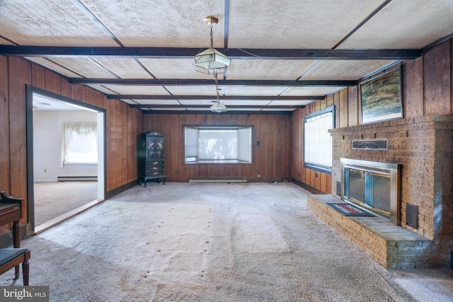 52 Golden Maple Ln, Maurertown, VA 22644 - unfurnished living room featuring a baseboard heating unit, light carpet, wood walls, a brick fireplace, and baseboard heating