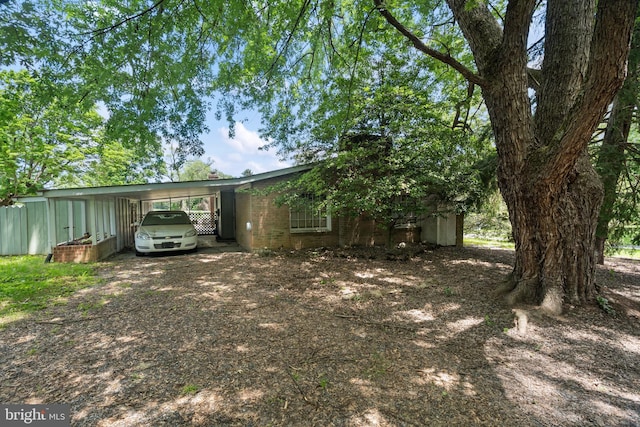 52 Golden Maple Ln, Maurertown, VA 22644 - view of front of home with dirt driveway, a carport, and brick siding