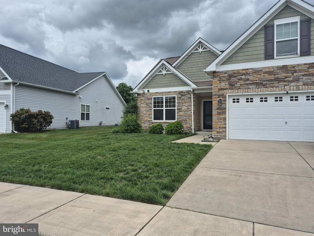 226 N Red Haven Ln, Dover, DE 19901 - craftsman-style house with stone siding, concrete driveway, a front yard, and cooling unit