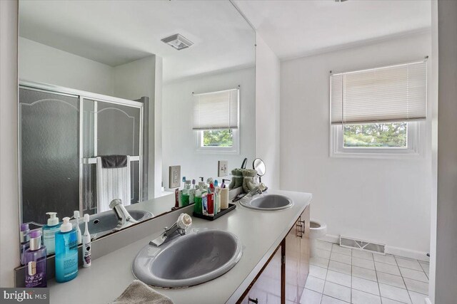 17 Bermuda Ave, Bridgeton, NJ 08302 - bathroom with double vanity, tile patterned floors, a shower stall, toilet, and baseboards