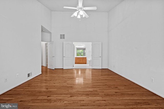 1903 Scottish Isle Ct, Abingdon, MD 21009 - empty room with wood finished floors, a ceiling fan, a high ceiling, and baseboards