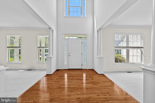 1903 Scottish Isle Ct, Abingdon, MD 21009 - carpeted entrance foyer featuring ornate columns, ornamental molding, baseboards, wood finished floors, and a high ceiling