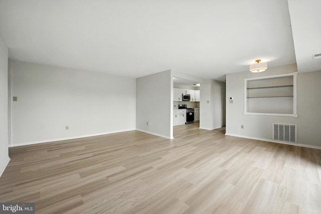 218 Locust St SE Unit 151, Vienna, VA 22180 - unfurnished living room featuring light wood finished floors and baseboards