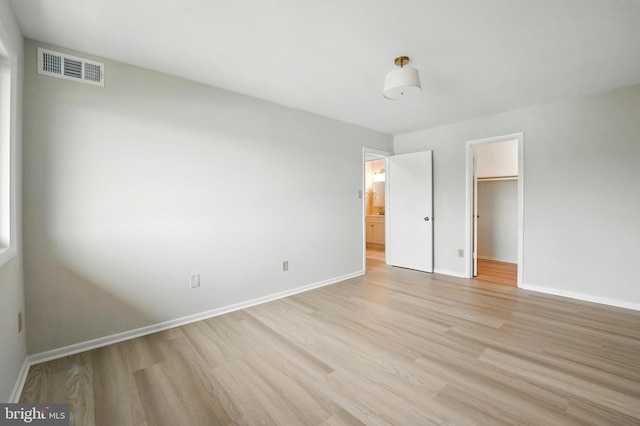 218 Locust St SE Unit 151, Vienna, VA 22180 - unfurnished bedroom featuring light wood-type flooring, a spacious closet, and a closet