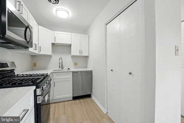 218 Locust St SE Unit 151, Vienna, VA 22180 - kitchen with stainless steel appliances, light wood finished floors, light countertops, and white cabinets