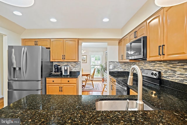 408 Maravista Ct, Silver Spring, MD 20905 - kitchen featuring appliances with stainless steel finishes, a sink, backsplash, dark stone countertops, and recessed lighting