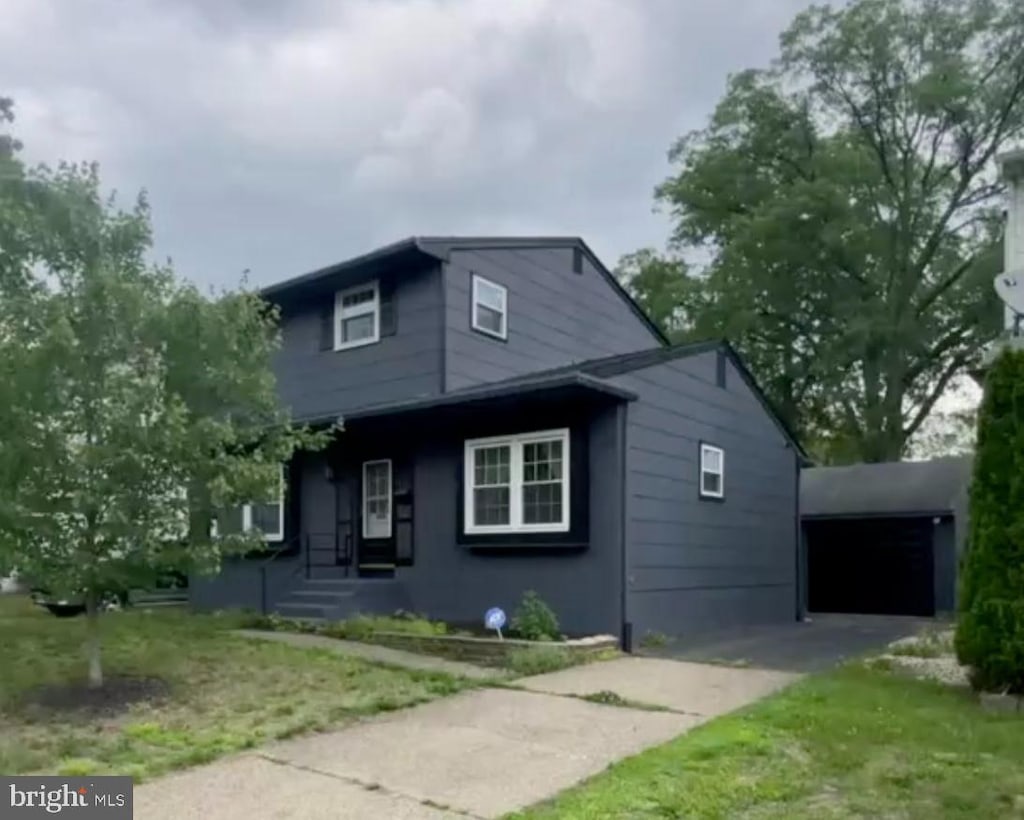 4732 Oak Ter, Pennsauken, NJ 08109 - view of side of property with concrete driveway, a garage, and a yard