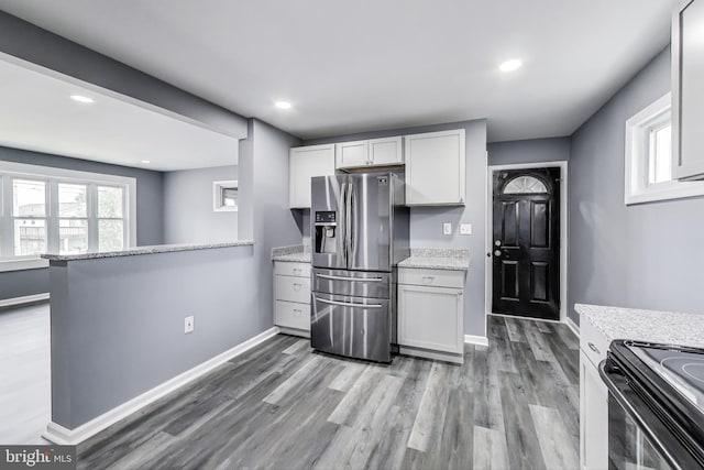 2500 Gehb Ave, Baltimore, MD 21227 - kitchen featuring stainless steel fridge with ice dispenser, wood finished floors, light stone counters, white cabinetry, and recessed lighting