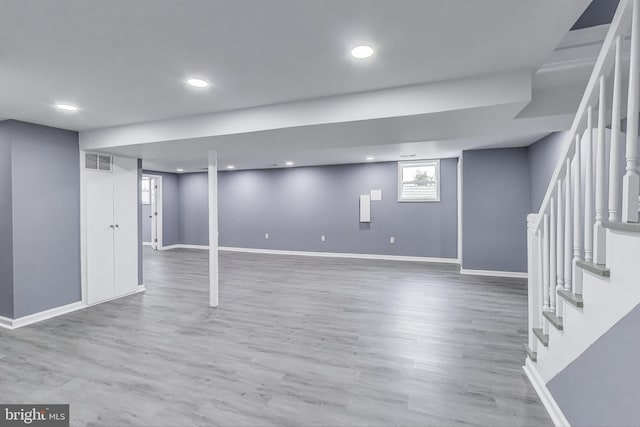 2500 Gehb Ave, Baltimore, MD 21227 - below grade area featuring stairway, baseboards, wood finished floors, and recessed lighting