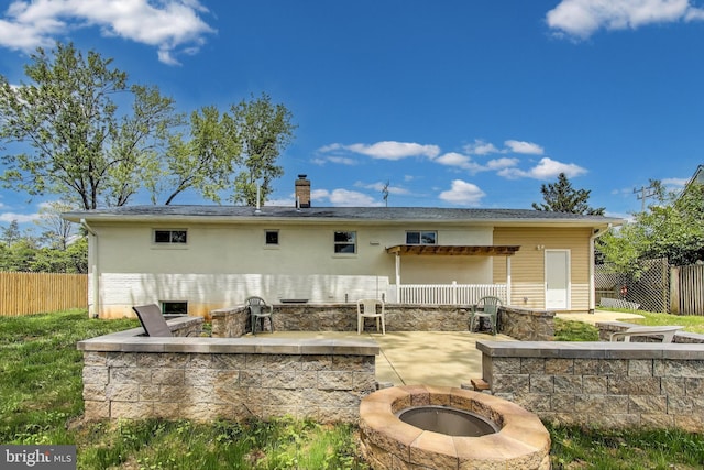 2500 Gehb Ave, Baltimore, MD 21227 - rear view of house featuring an outdoor fire pit, a patio, and a chimney