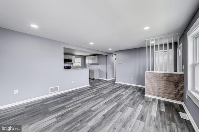 2500 Gehb Ave, Baltimore, MD 21227 - unfurnished living room featuring dark wood-style flooring, baseboards, and recessed lighting
