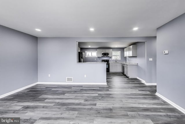 2500 Gehb Ave, Baltimore, MD 21227 - unfurnished living room featuring dark wood finished floors, baseboards, and recessed lighting