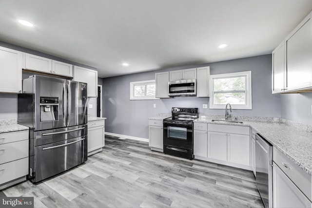 2500 Gehb Ave, Baltimore, MD 21227 - kitchen featuring stainless steel appliances, a sink, recessed lighting, healthy amount of natural light, and light stone counters
