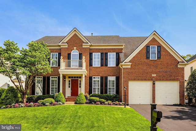 43313 Jerpoint Ct, Chantilly, VA 20152 - colonial home with brick siding, driveway, a front lawn, a balcony, and an attached garage