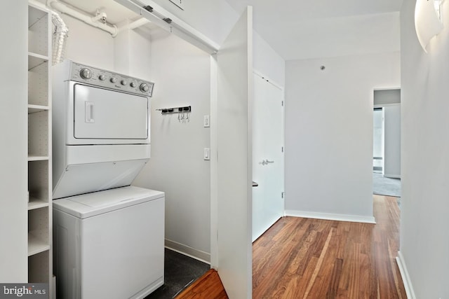 2101 Market St Unit 902, Philadelphia, PA 19103 - washroom with stacked washer / drying machine, wood finished floors, and baseboards