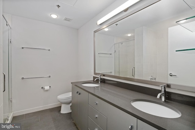 2101 Market St Unit 902, Philadelphia, PA 19103 - bathroom featuring double vanity, a stall shower, toilet, baseboards, and tile patterned floors