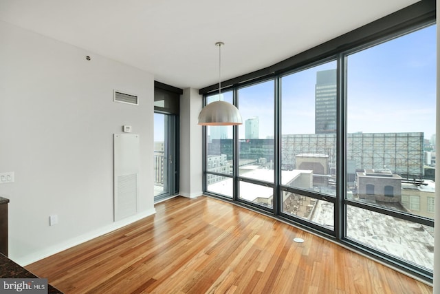 2101 Market St Unit 902, Philadelphia, PA 19103 - unfurnished dining area with expansive windows, wood finished floors, and baseboards