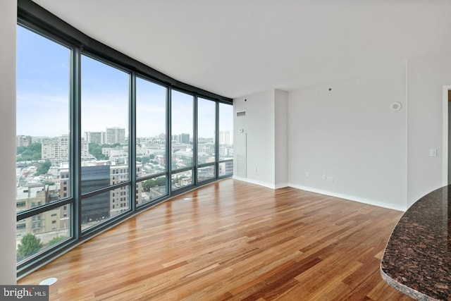 2101 Market St Unit 902, Philadelphia, PA 19103 - spare room with a view of city, light wood finished floors, floor to ceiling windows, and baseboards
