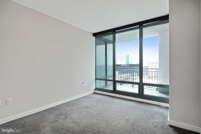 2101 Market St Unit 902, Philadelphia, PA 19103 - spare room with baseboards, dark carpet, and expansive windows
