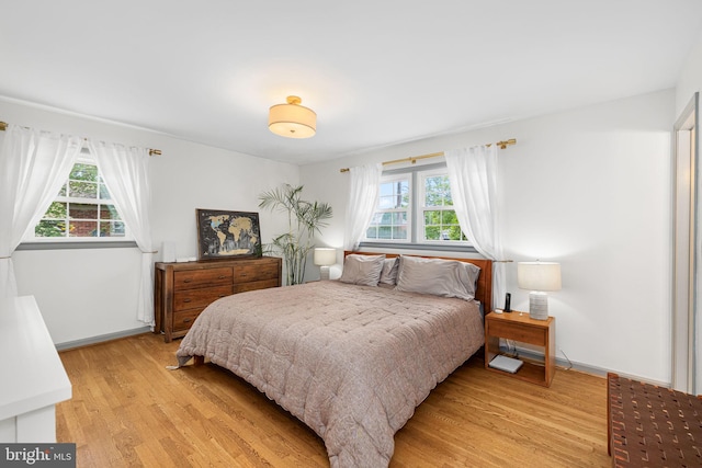 4301 Ivanhoe Pl, Alexandria, VA 22304 - bedroom featuring multiple windows, light wood-style floors, and baseboards