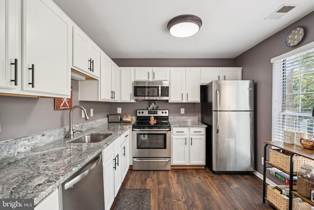 11193 Rienzi Pl Unit 203, Manassas, VA 20109 - kitchen featuring stainless steel appliances, a sink, white cabinets, and light stone counters